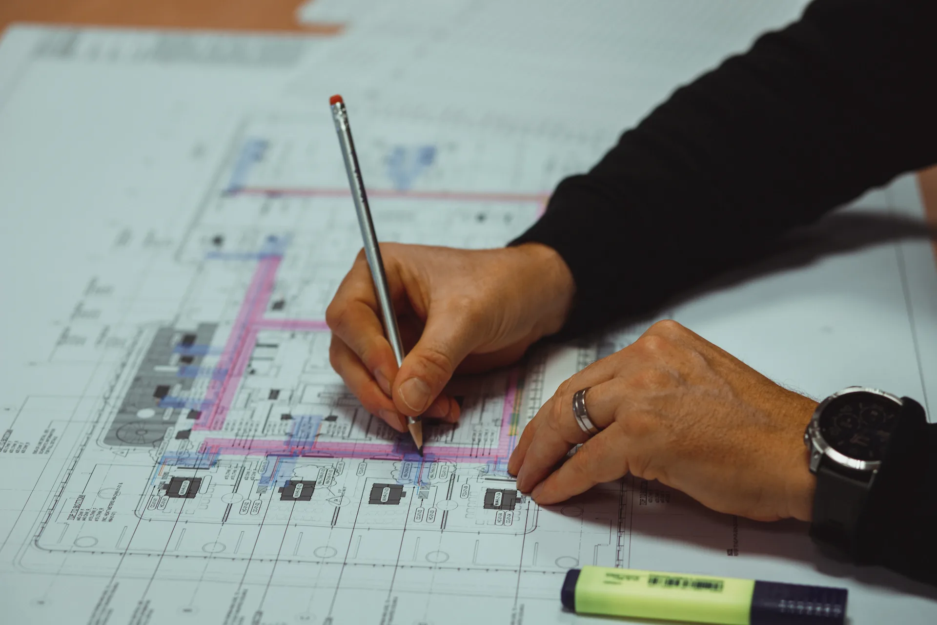 Hands sketching technical details as part of the modelling and planning process.