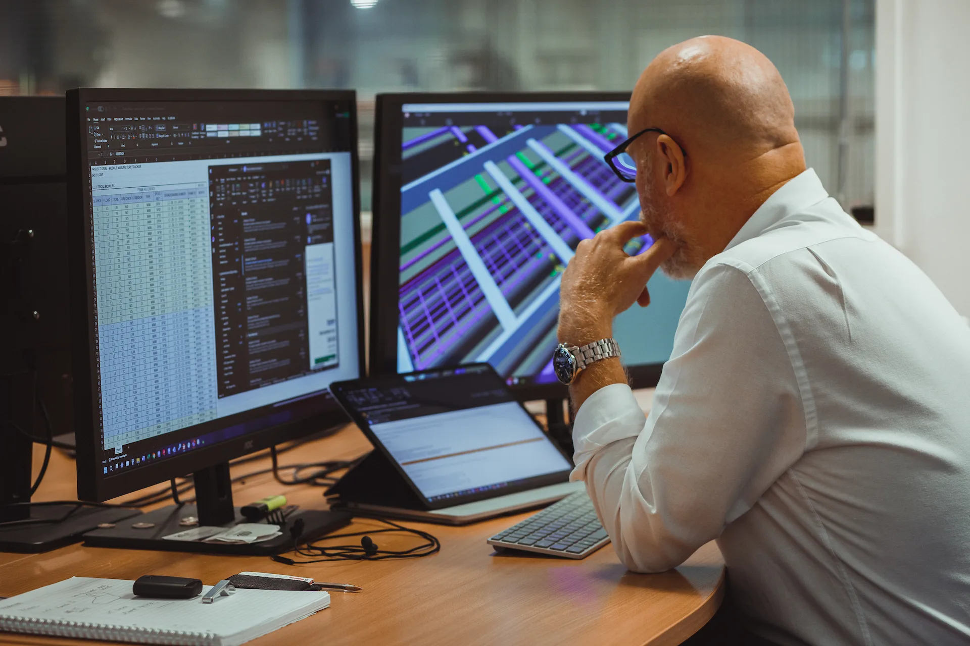 A staff member working at a desk in an office.